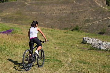 Image showing Mountain biking happy sportive girl relax in meadows sunny countryside