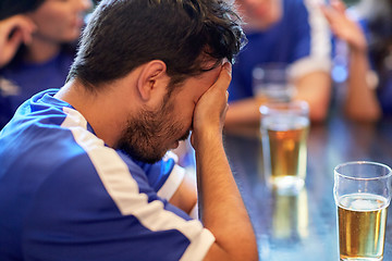 Image showing close up of sad football fan at bar or pub