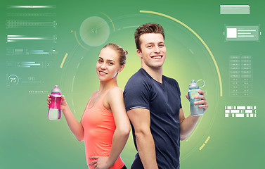 Image showing sportive man and woman with water bottles