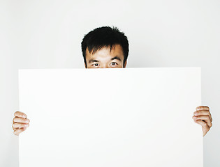 Image showing pretty cool asian man holding empty white plate smiling