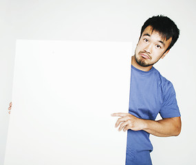 Image showing pretty cool asian man holding empty white plate smiling