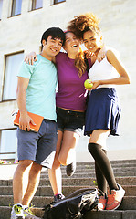 Image showing cute group of teenages at the building of university with books 