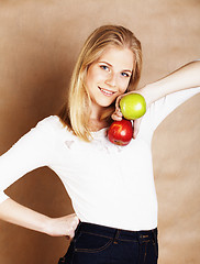 Image showing young blond woman with green and red apple, good choice, diet concept 