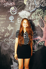 Image showing portrait of happy cute student in classroom at blackboard back to school having fun, girl at college