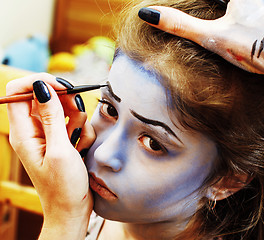 Image showing little cute child making facepaint on birthday party, zombie Apo