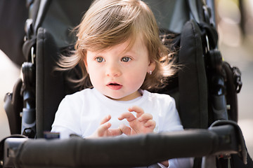 Image showing baby girl sitting in the pram