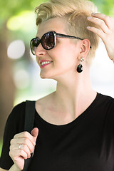 Image showing young woman with short blond hair and sunglasses