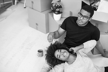 Image showing African American couple relaxing in new house