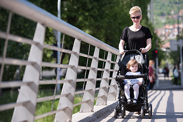 Image showing mother pushed her baby daughter in a stroller