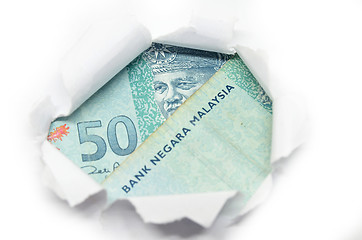 Image showing Malaysia currency peeking through white paper