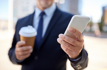 Image showing senior businessman with smartphone and coffee
