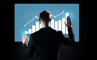 Image showing businessman touching virtual screen with chart