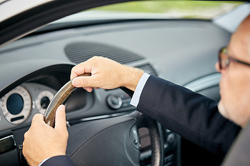 Image showing senior businessman hands driving car