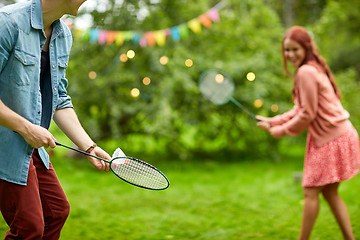 Image showing happy couple playing badminton at summer garden