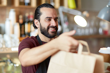 Image showing man or waiter with coffee and paper bag at bar