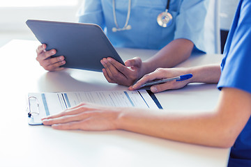 Image showing close up of doctors with tablet pc at hospital