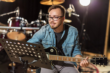 Image showing man playing guitar at studio rehearsal