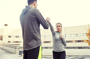 Image showing woman with trainer working out self defense strike