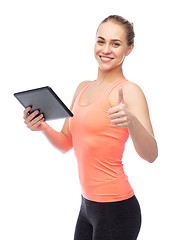 Image showing happy smiling sportive young woman with tablet pc