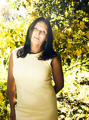 Image showing mature real brunette woman in green spring park, lifestyle conce