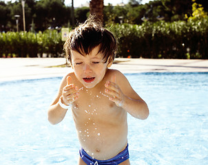 Image showing little cute real boy in swimming pool close up smiling