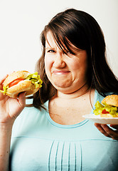 Image showing fat white woman having choice between hamburger and salad close 