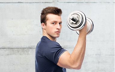 Image showing sportive man flexing muscles with dumbbell