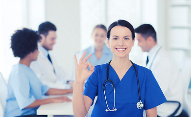 Image showing happy doctor over group of medics at hospital