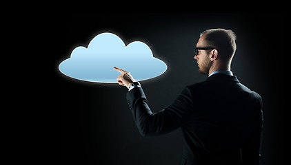 Image showing businessman pointing finger to cloud projection