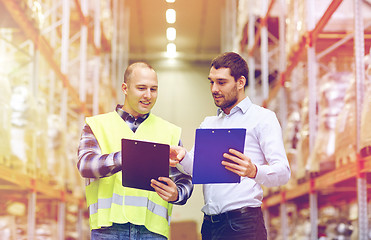 Image showing worker and businessmen with clipboard at warehouse