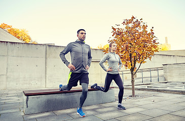 Image showing couple doing lunge exercise on city street