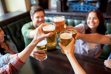 Image showing happy friends drinking beer at bar or pub