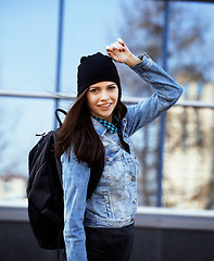 Image showing young pretty girl near business building walking