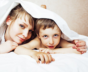 Image showing young blond woman with little boy in bed, mother and son, happy family 