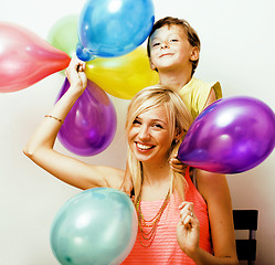 Image showing pretty real family with color balloons on white background, blon