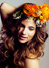 Image showing Beauty young woman with flowers and make up close up, real sprin