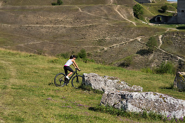 Image showing Mountain biking happy sportive girl relax in meadows sunny countryside