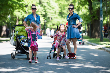 Image showing twins mother with children  in city park