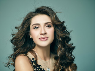 Image showing Pretty girl with long hair posing at studio