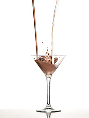 Image showing macro shoot with hot chocolate falling in glass on white in studio