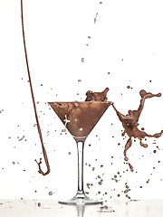 Image showing macro shoot with hot chocolate falling in glass on white in studio