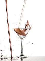 Image showing macro shoot with hot chocolate falling in glass on white in studio