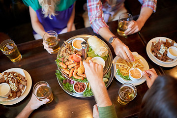 Image showing friends eating and drinking at bar or pub