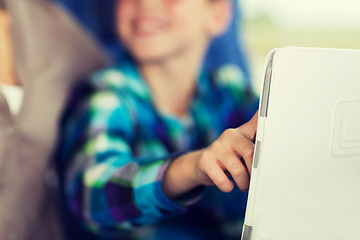 Image showing close up of boy with tablet pc in travel bus