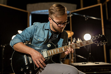 Image showing man playing guitar at studio rehearsal