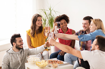 Image showing friends having party and clinking drinks at home