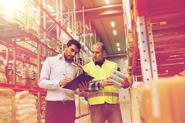 Image showing worker and businessmen with clipboard at warehouse