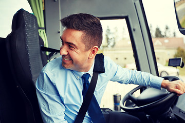 Image showing happy driver driving intercity bus