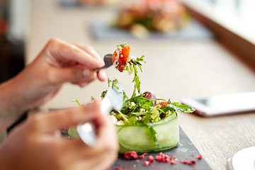 Image showing woman eating cottage cheese salad at restaurant