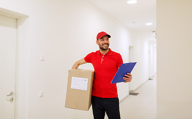 Image showing delivery man with box and clipboard in corridor